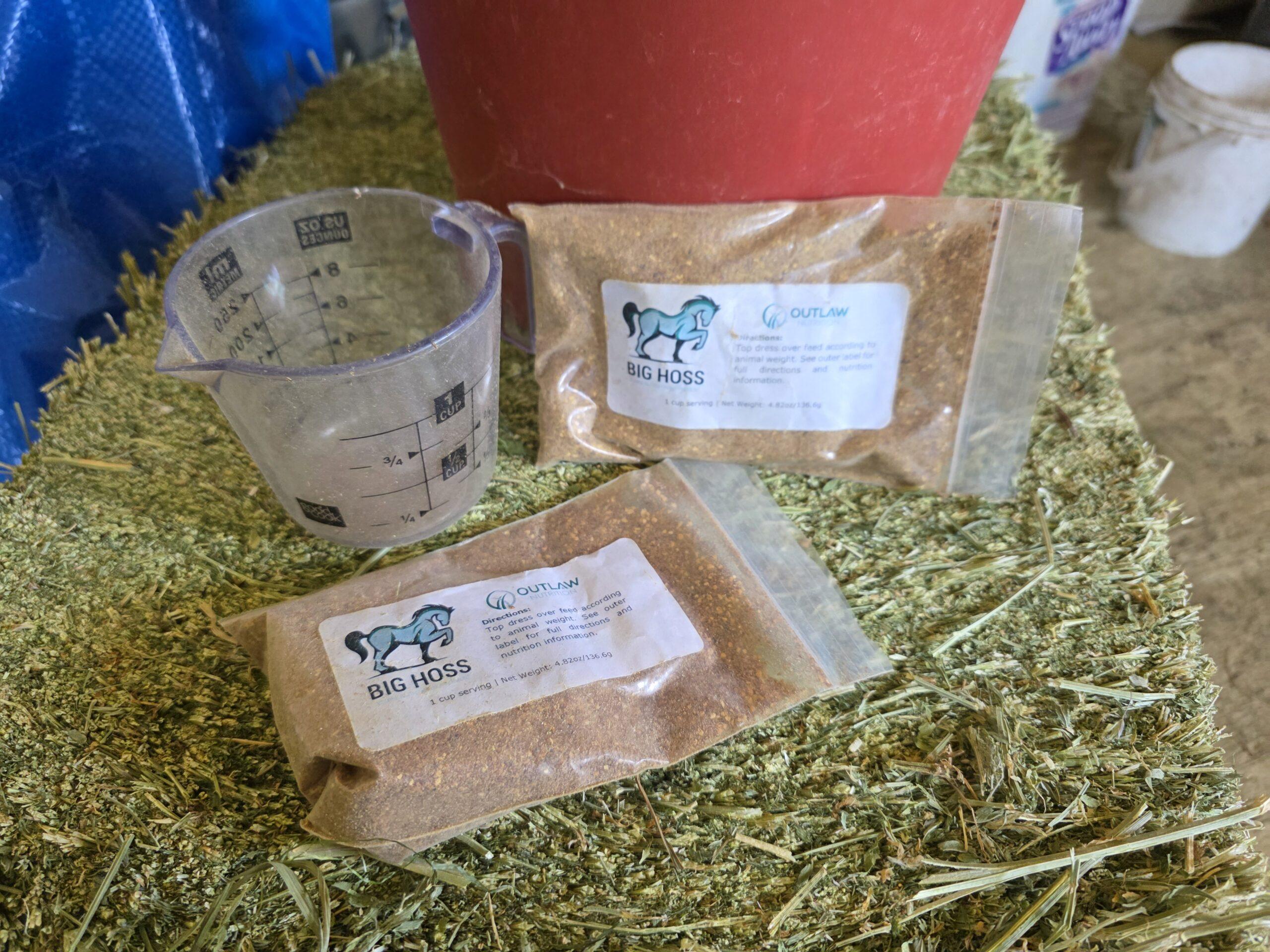 big hoss omega 3 fatty acid supplement on a cube of compressed hay