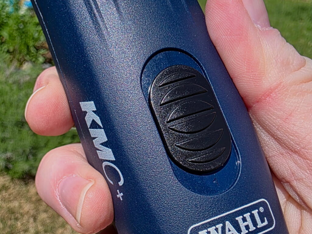 blue cordless clipper handle showing the two speed setting 