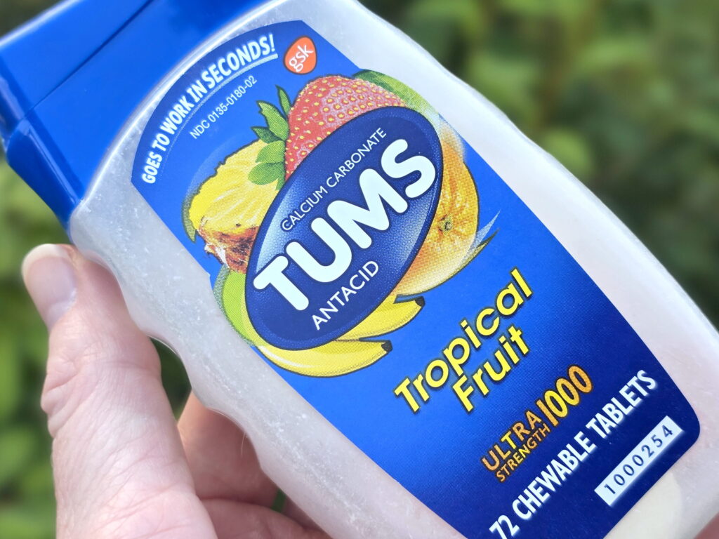 TUMS antacids bottle in a hand