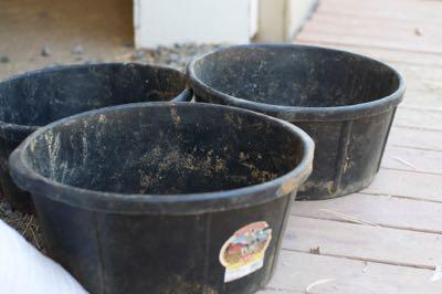 three large rubber feed tubs