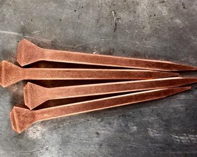 side view of copper horseshoe nails