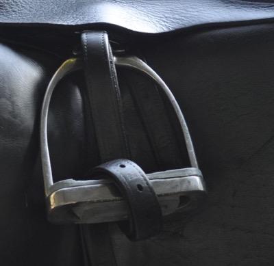 dressage saddle with rolled up stirrup