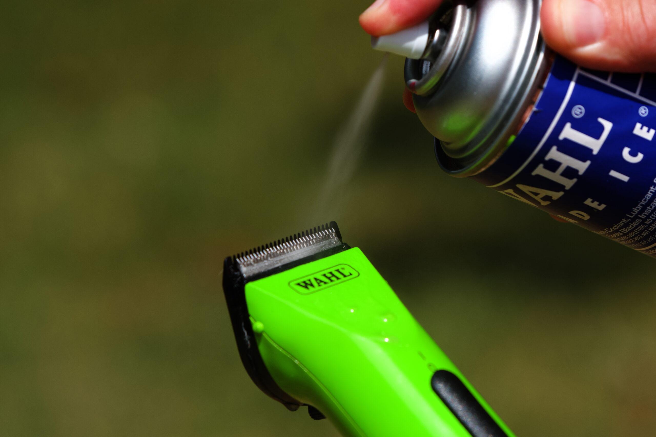 arco clippers and 5 in 1 blade being sprayed with clipper coolant