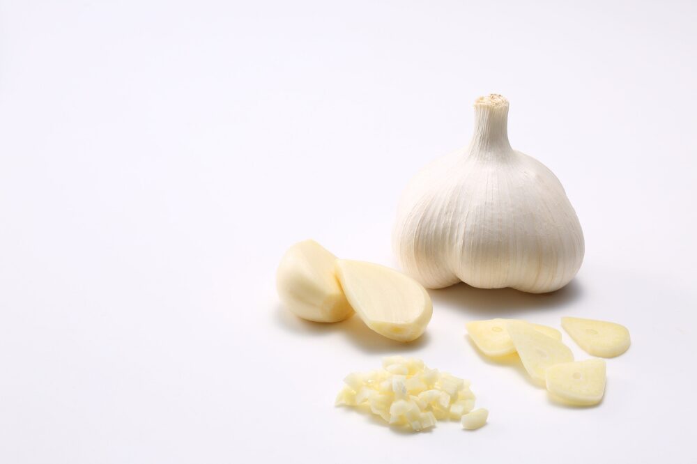 a garlic bulb shown with a few cloves of garlic