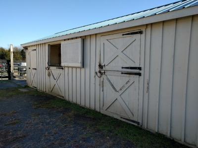 long barn with many stalls and dutch doors