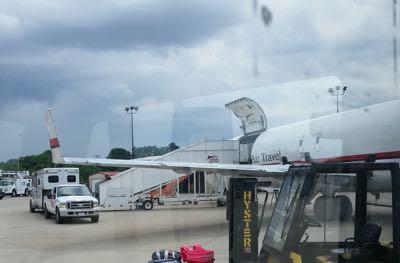 horse trailer parked at the ramp of an airplane