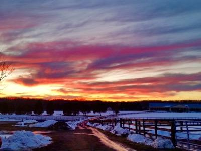 sunset over a snowy barn