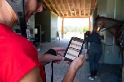 woman looking at her phone screen showing fitness tracking