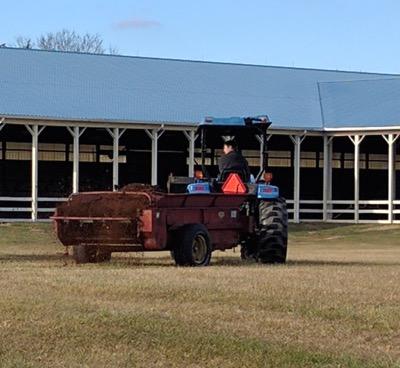 manure spreader putting compost on the fields