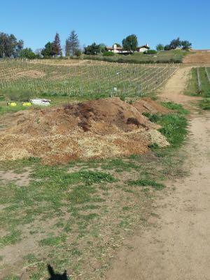 large compost pile in a field