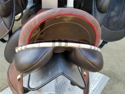 dressage saddle with patent leather and fabric piping