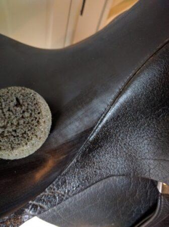 tack sponge cleaning the seat of a dressage saddle