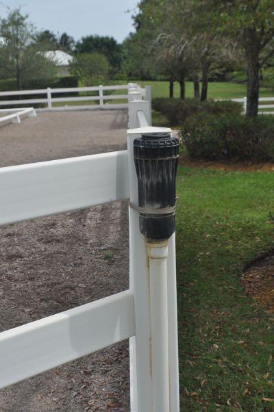 sprinkler on riding arena fence