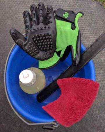 wash rack bucket with grooming gloves washcloth and shampoo