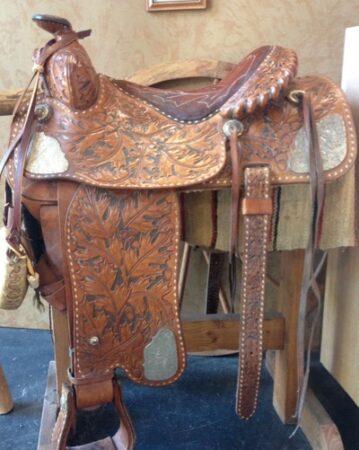 western saddle with lots of tooling and silver