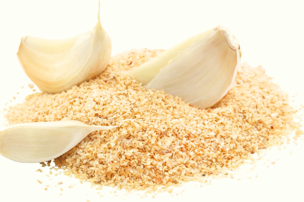 a few cloves of garlic sitting in diced garlic
