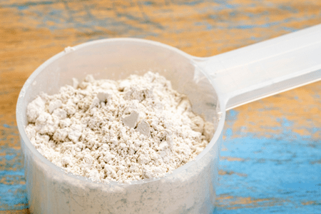 a scooper filled with diatomaceous earth for horses