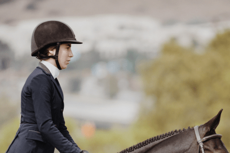 horseback riding helmet on a girl at a horse show
